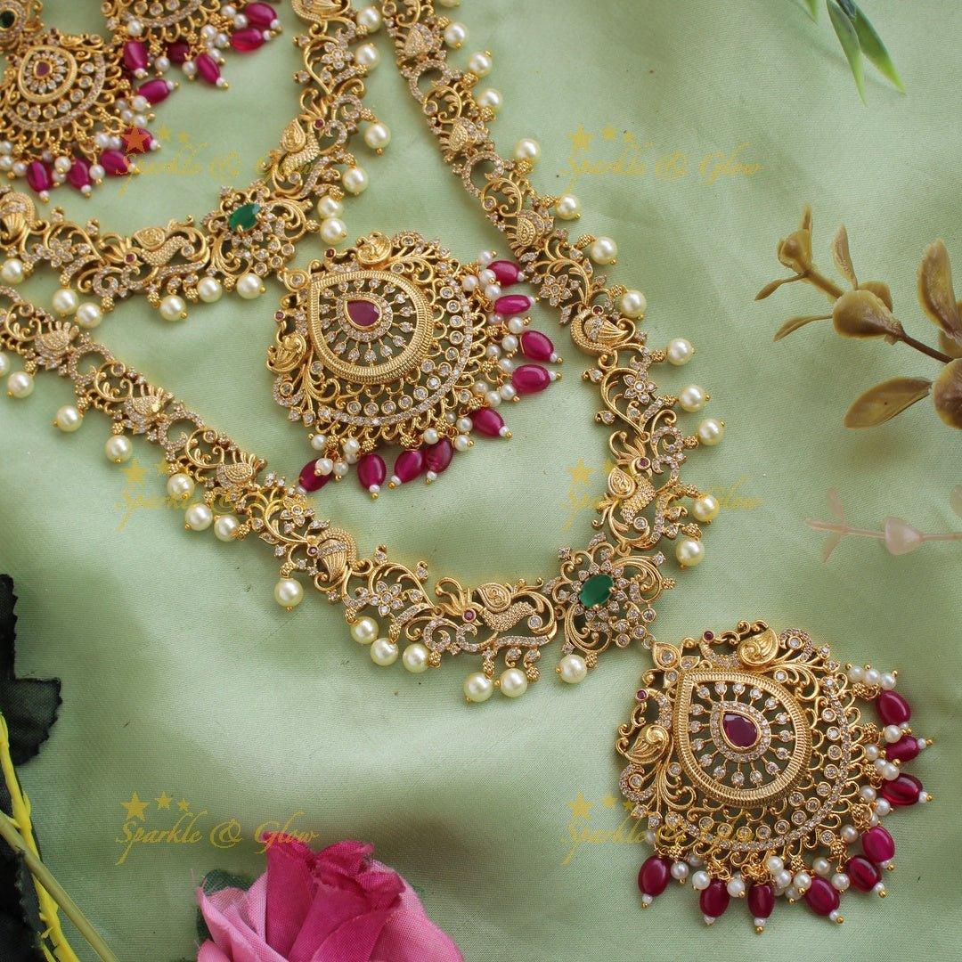 Stunning Premium Matt peacock floral design Necklace set with maang tikka and CZ stones pearls Red beads - Sparkle and Glow