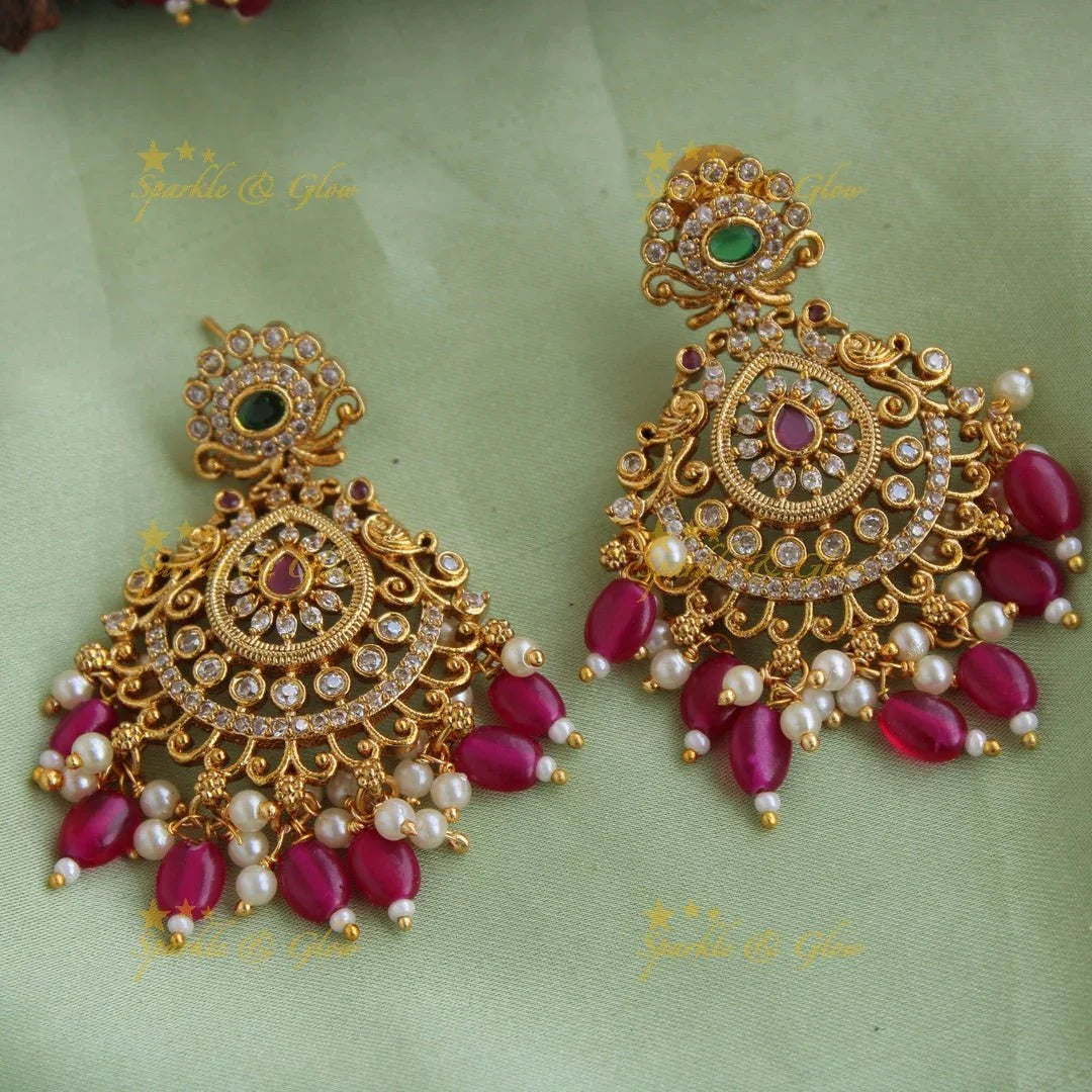Stunning Premium Matt peacock floral design Necklace set with maang tikka and CZ stones pearls Red beads - Sparkle and Glow